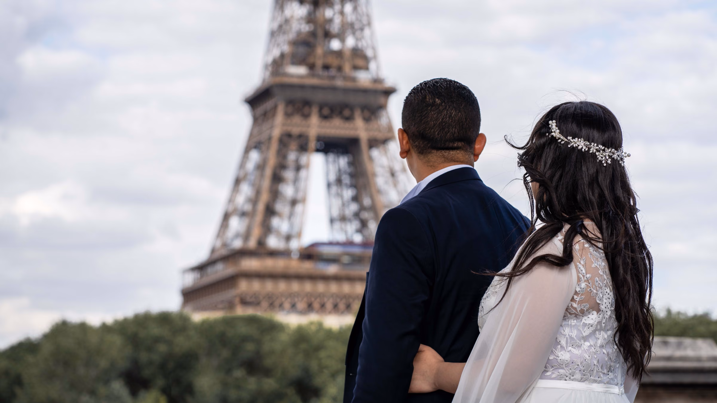 The couple from behind, facing the Eiffel Tower