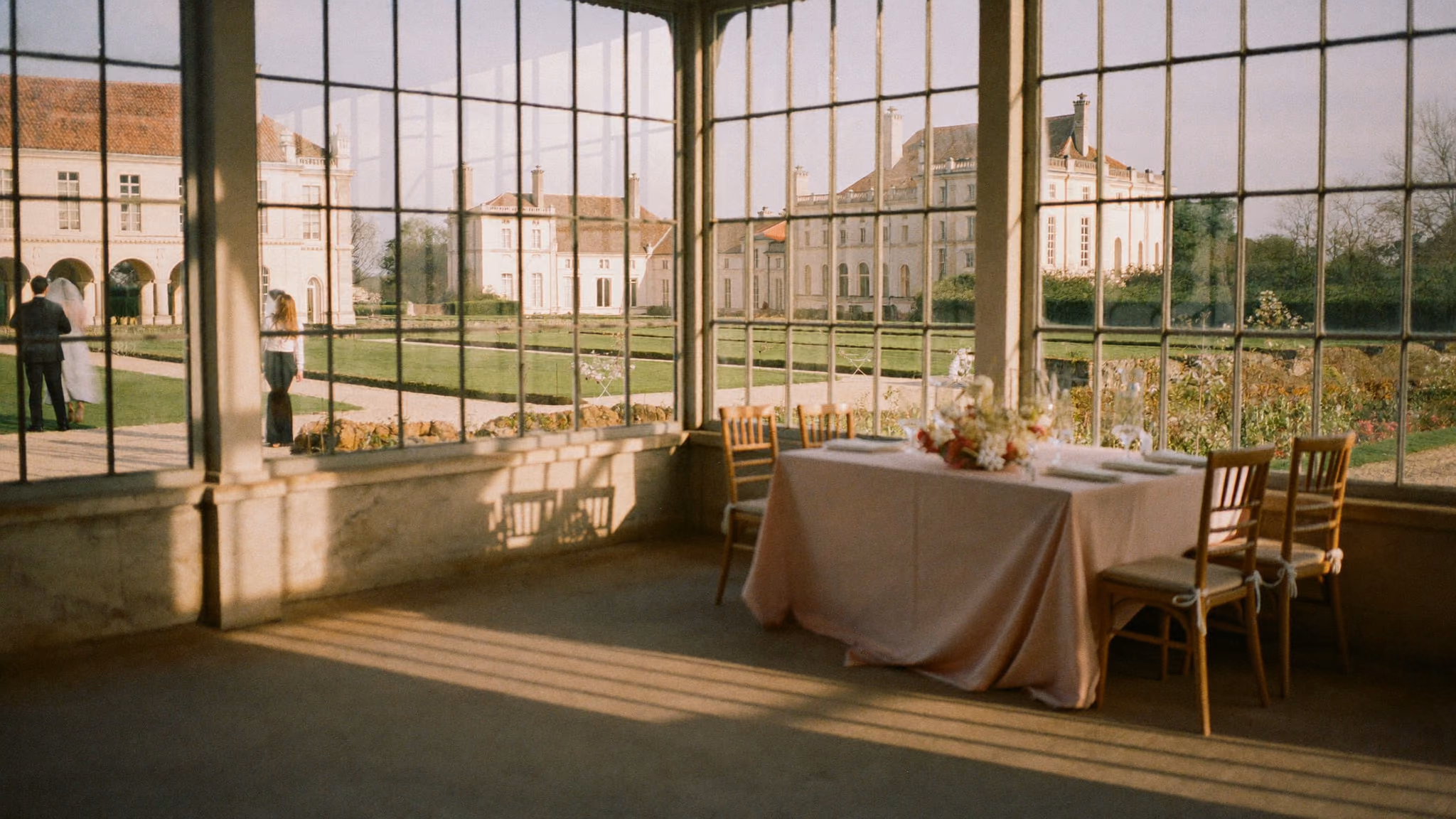 A glass orangery in late afternoon light